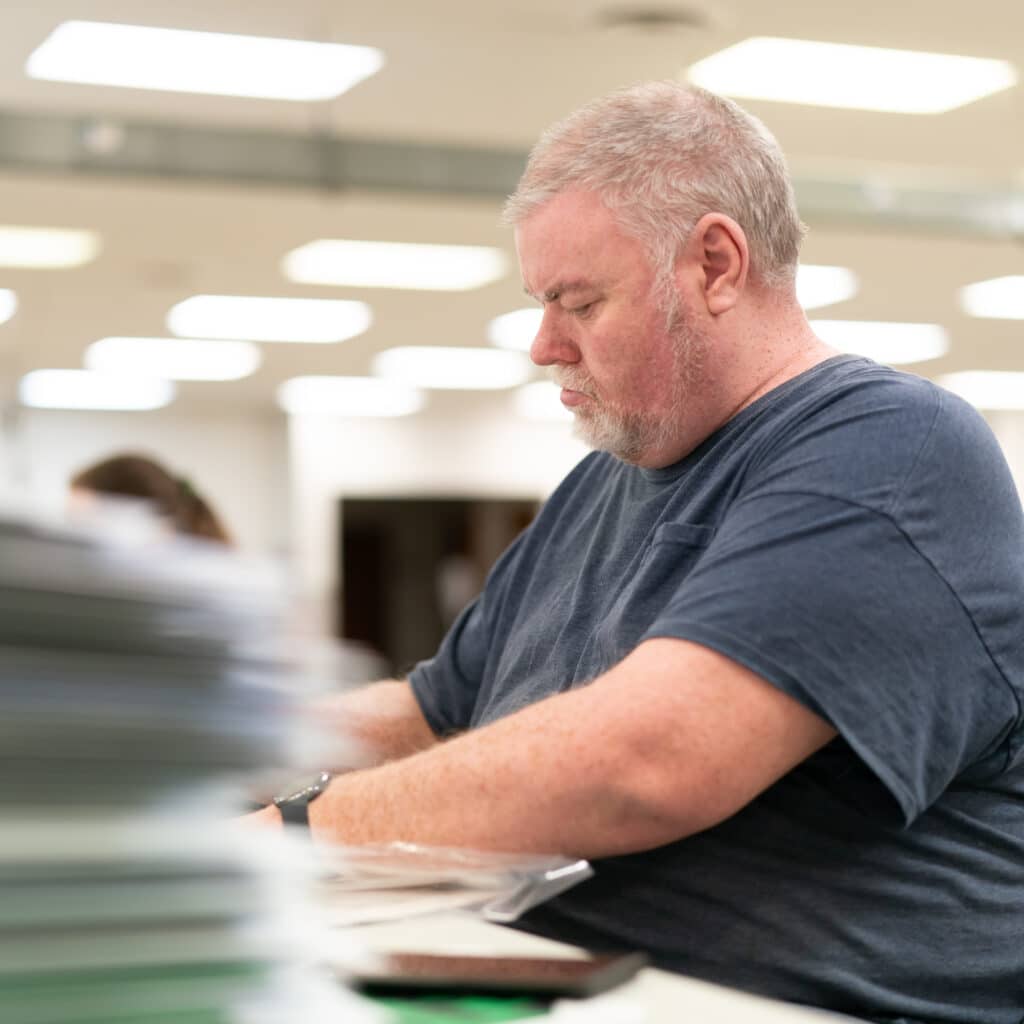 Man working at table - New Hope Services - New Hope Services